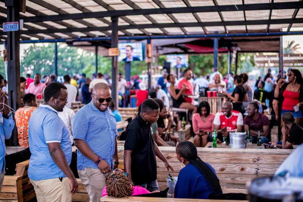 Vibrant outdoor social scene with diverse crowd in Dar es Salaam, Tanzania.